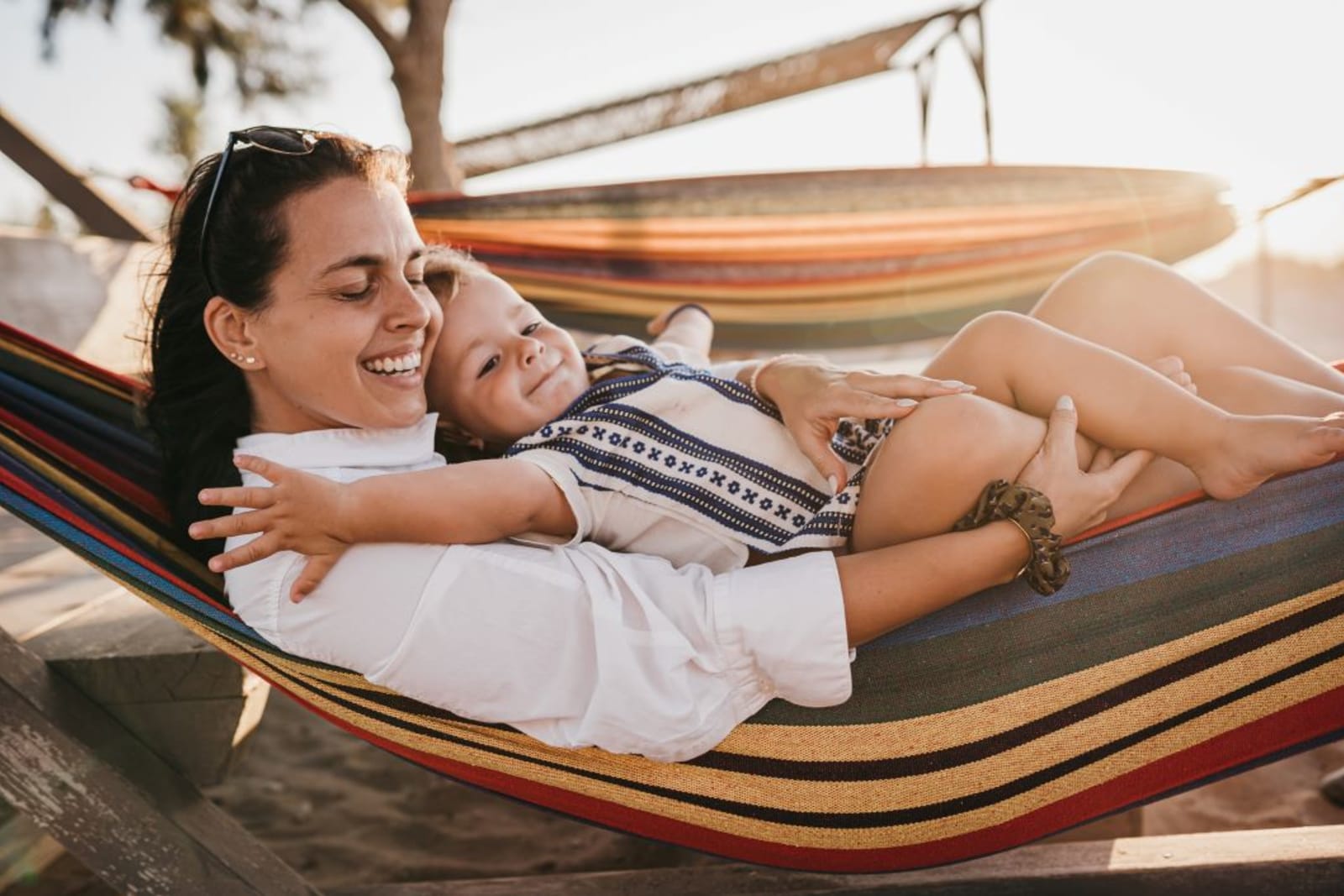 Mother and toddler relaxing in hammock