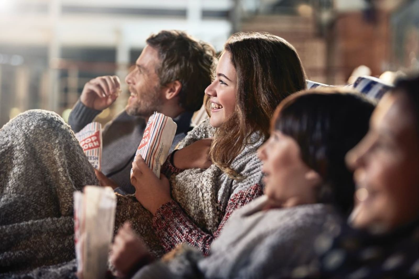 Family watching a movie under the stars aboard a Princess Cruises ship