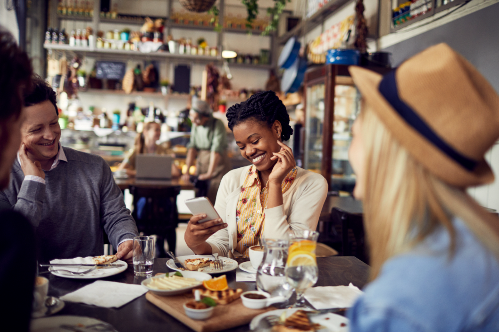 A group of friends dining at a restaurant during a layover