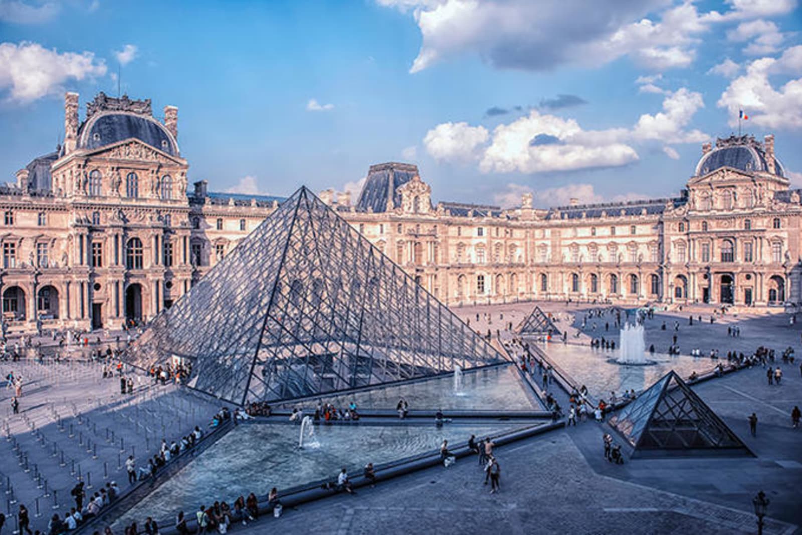 Louvre museum in Paris on a slightly cloudy day