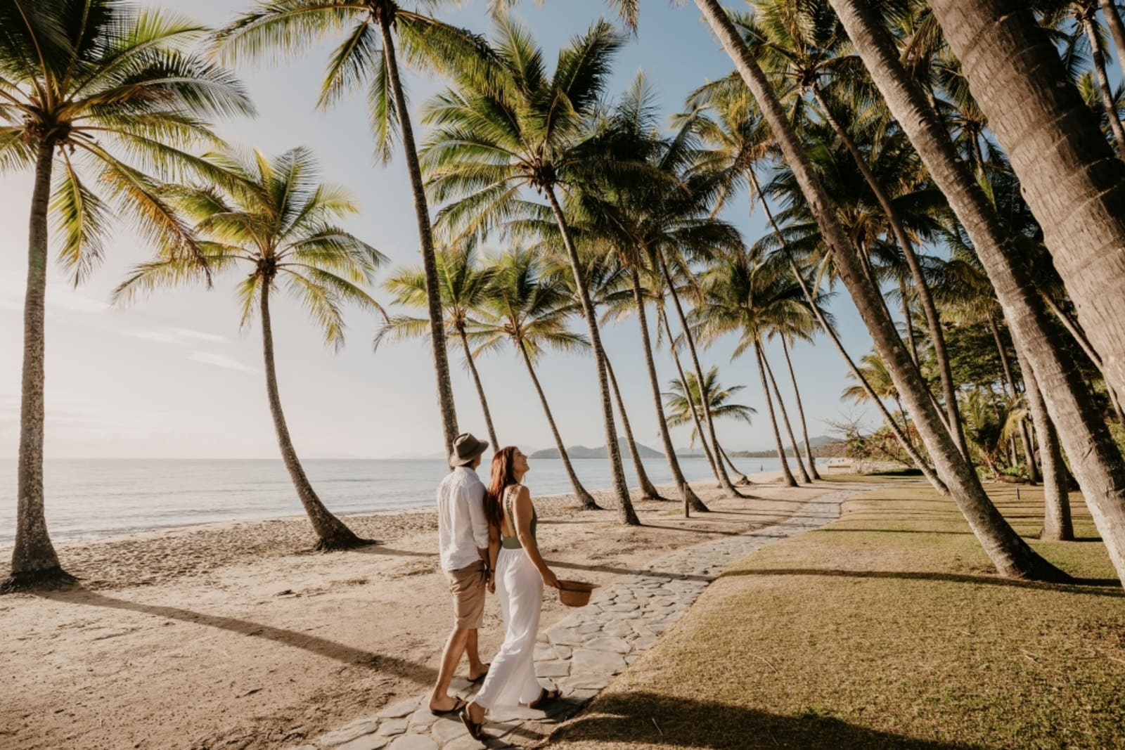 Couple strolling on beach promenade in Palm Cove