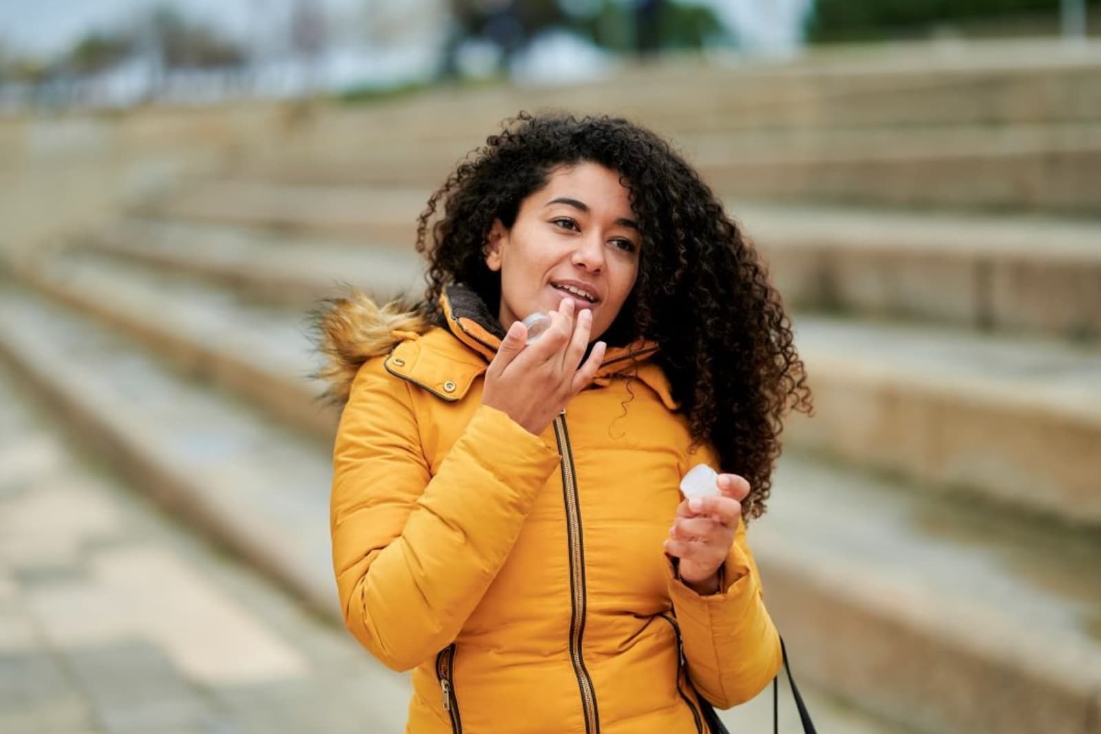 Woman applying lip balm in winter