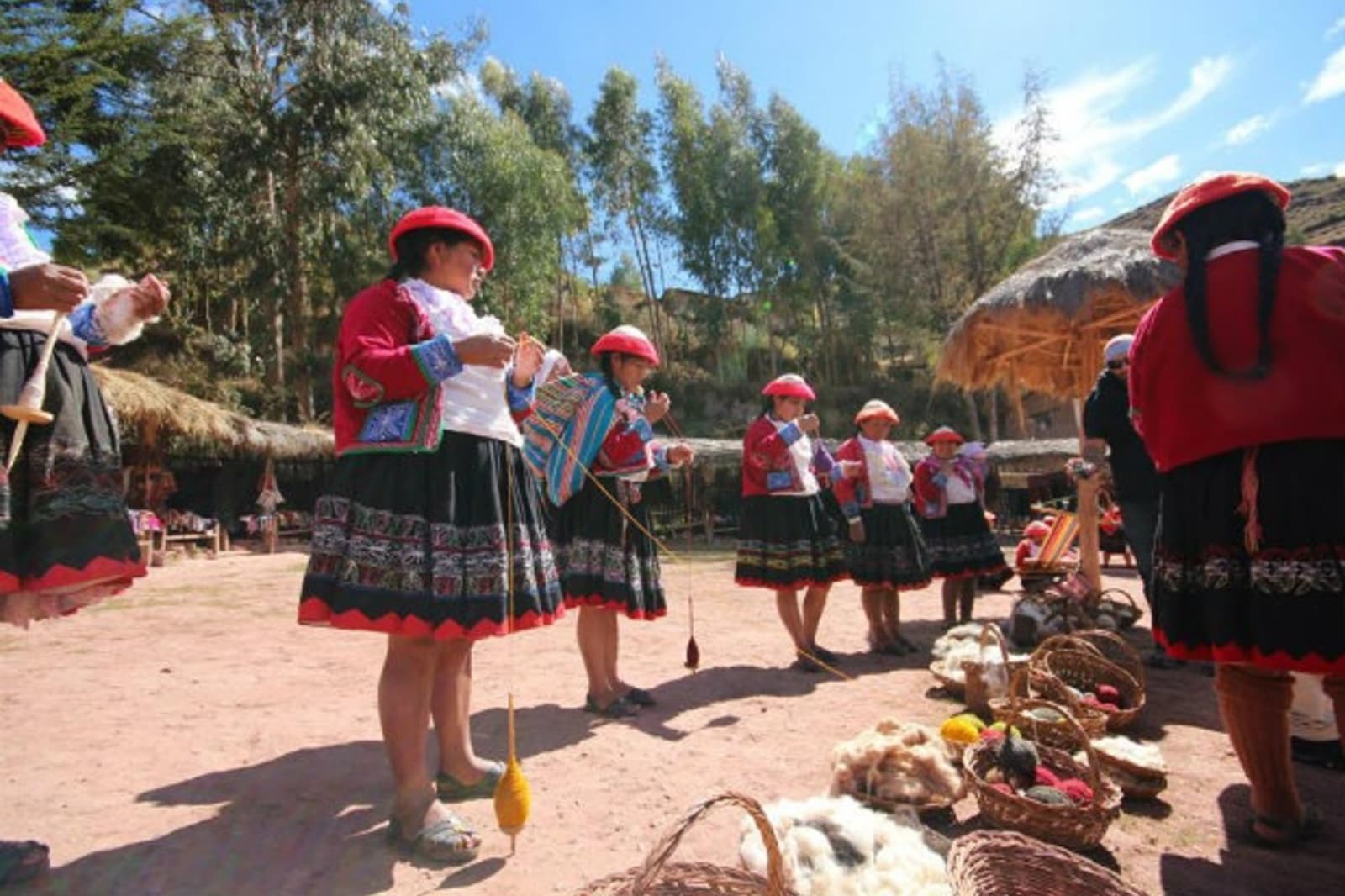 Group of women weaving clothing on a sunny day
