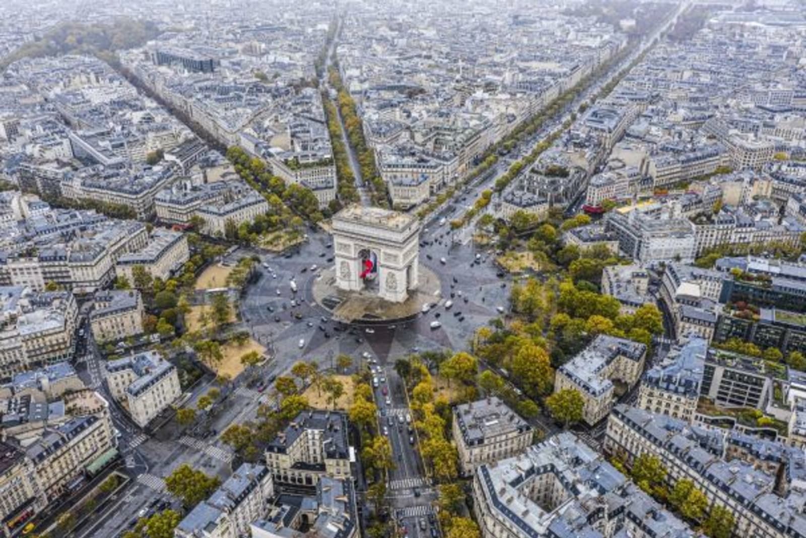 Aerial view of the Arc de triomphe and surrounding buildings and greenery