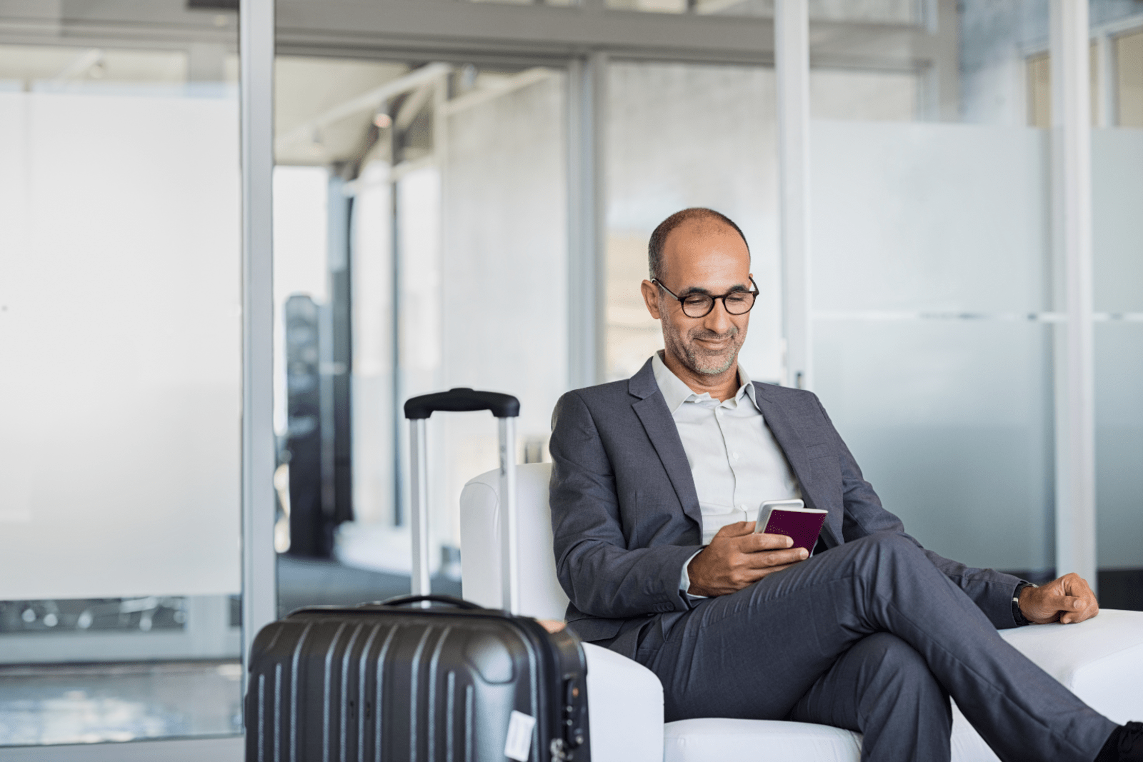Man with a briefcase looking at his phone