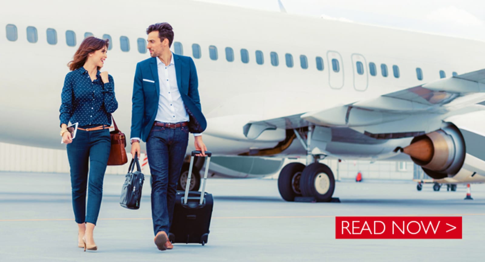 Businessman and business woman walking across the tarmac