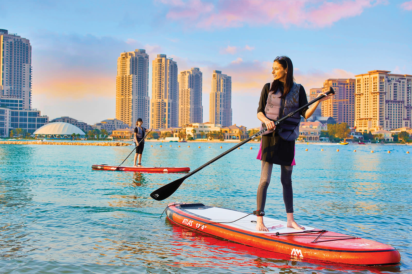 Women on stand-up paddleboards in Qatar