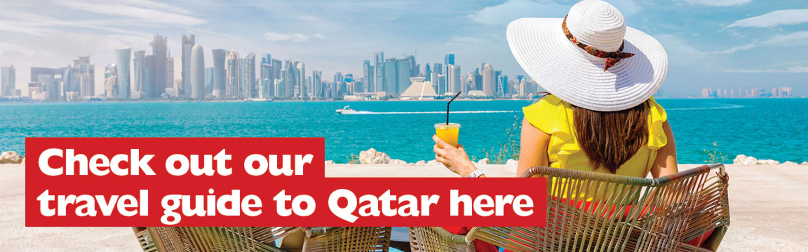 Check out our travel guide to Qatar here | woman drinking an orange juice in a beach chair, looking out over the sea at the city of Qatar