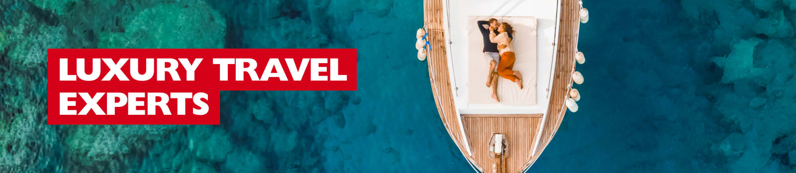 Luxury Travel Experts - couple cuddling on the bow of a luxury ship