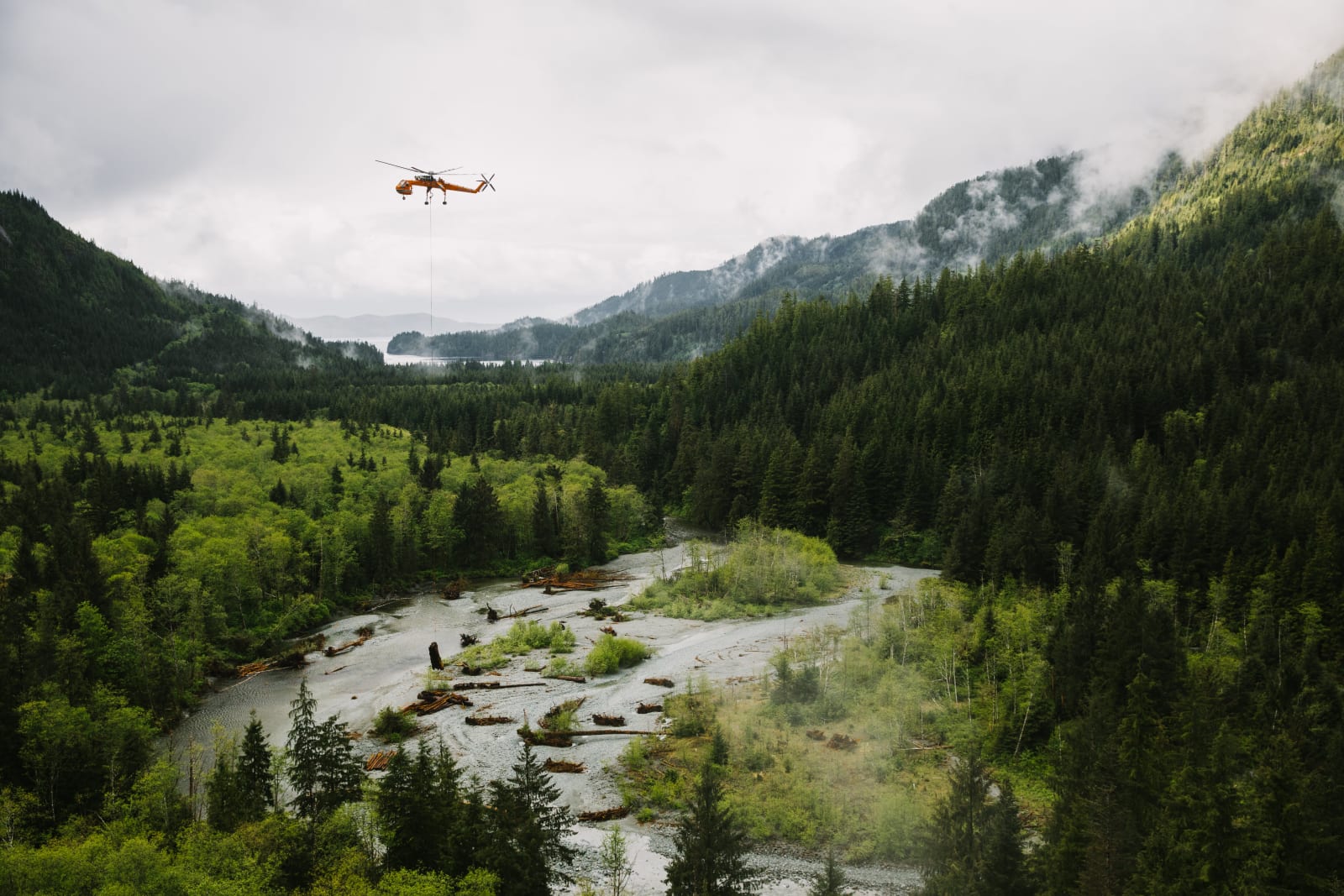 Air Crane lowering logs into a flooded river
