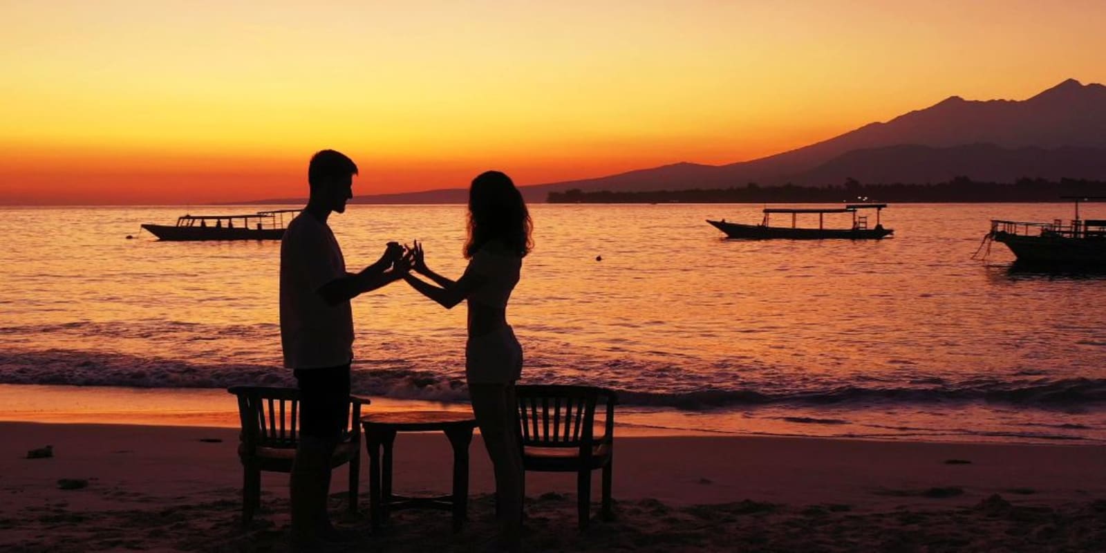 A couple on a beach holding hands