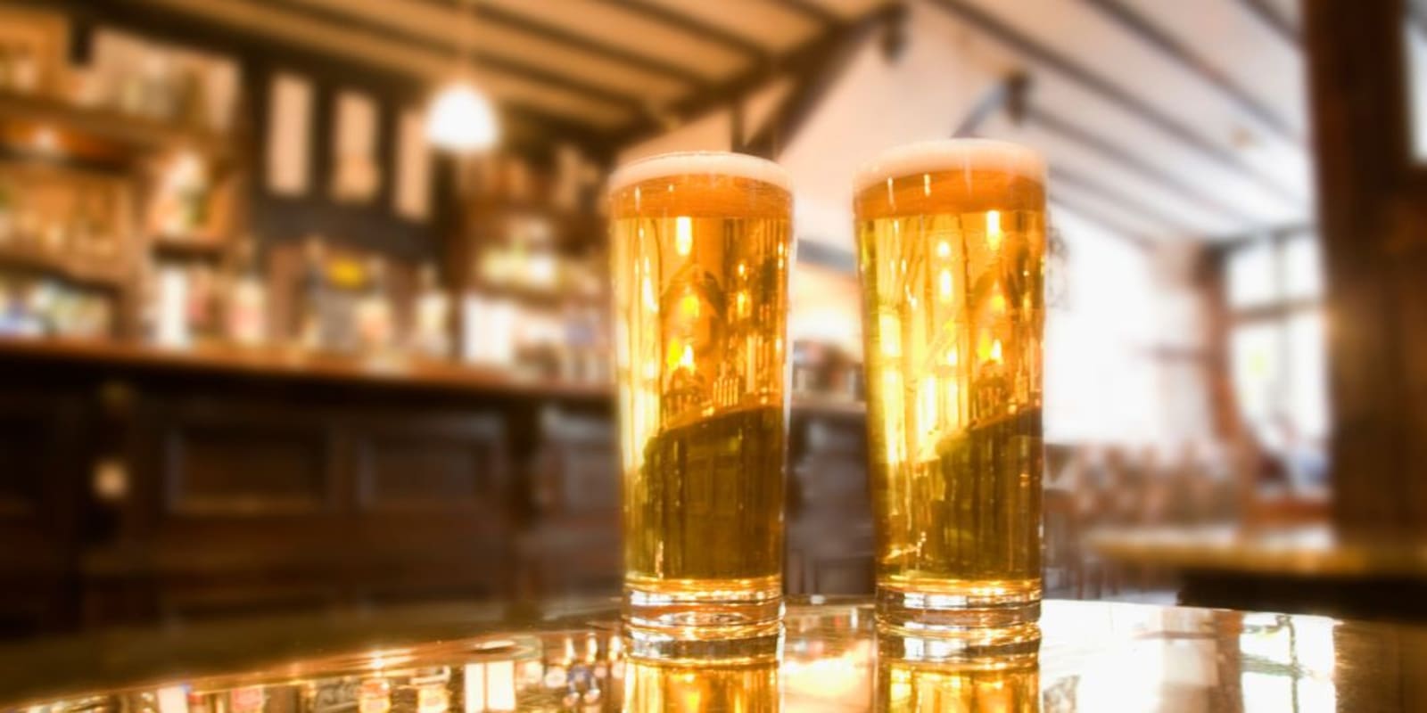 Two glasses of beer on a table in an English pub