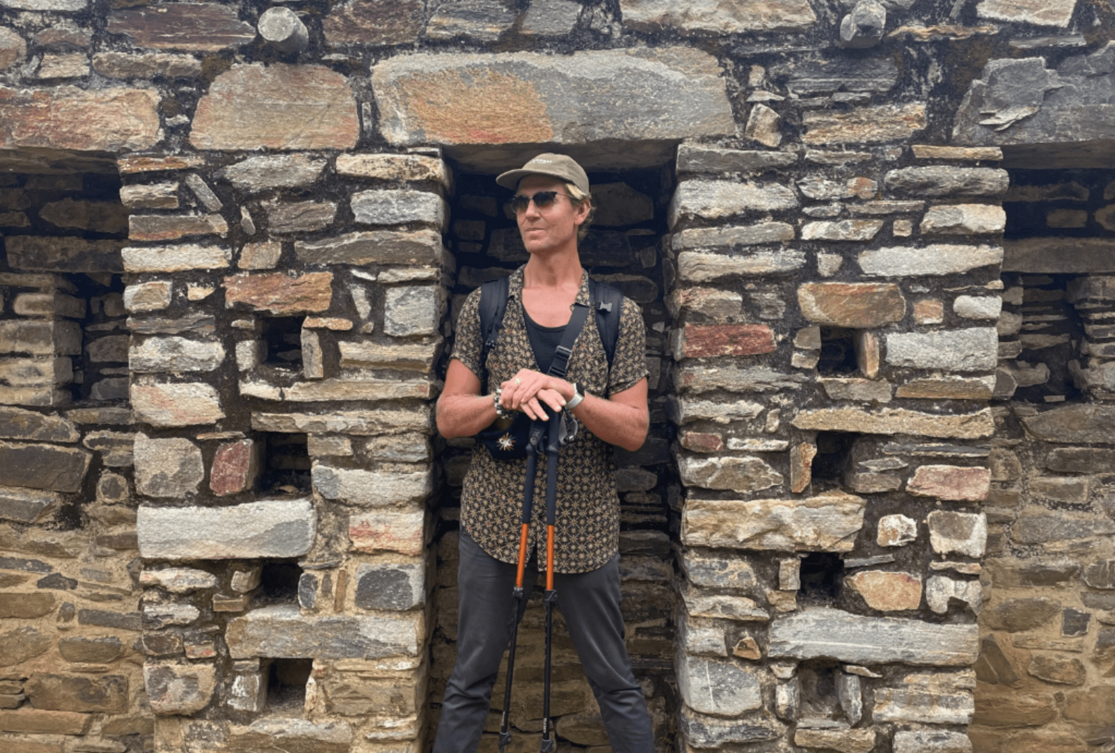 Jacob Stanley stands in a stone alcove among the ruins of the ancient Incan city of Choquequirao, Peru