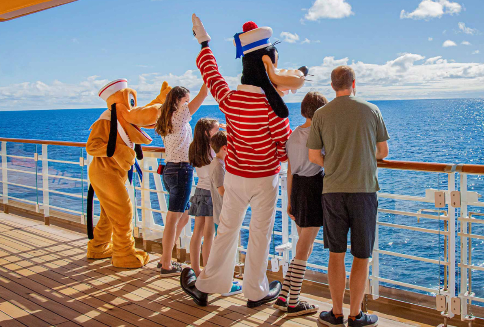 Goofy, Pluto and friends wave to the distant horizon aboard a Disney Cruise line vessel
