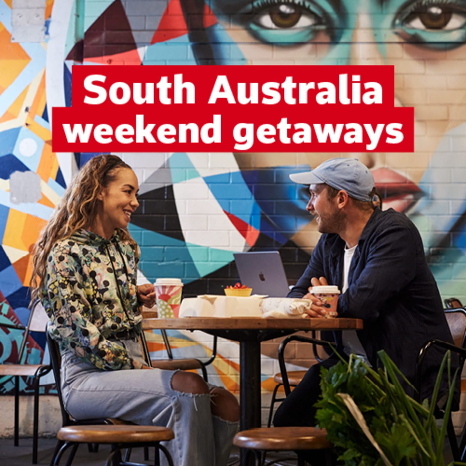 south australia weekend getaways text above couple sitting in cafe 