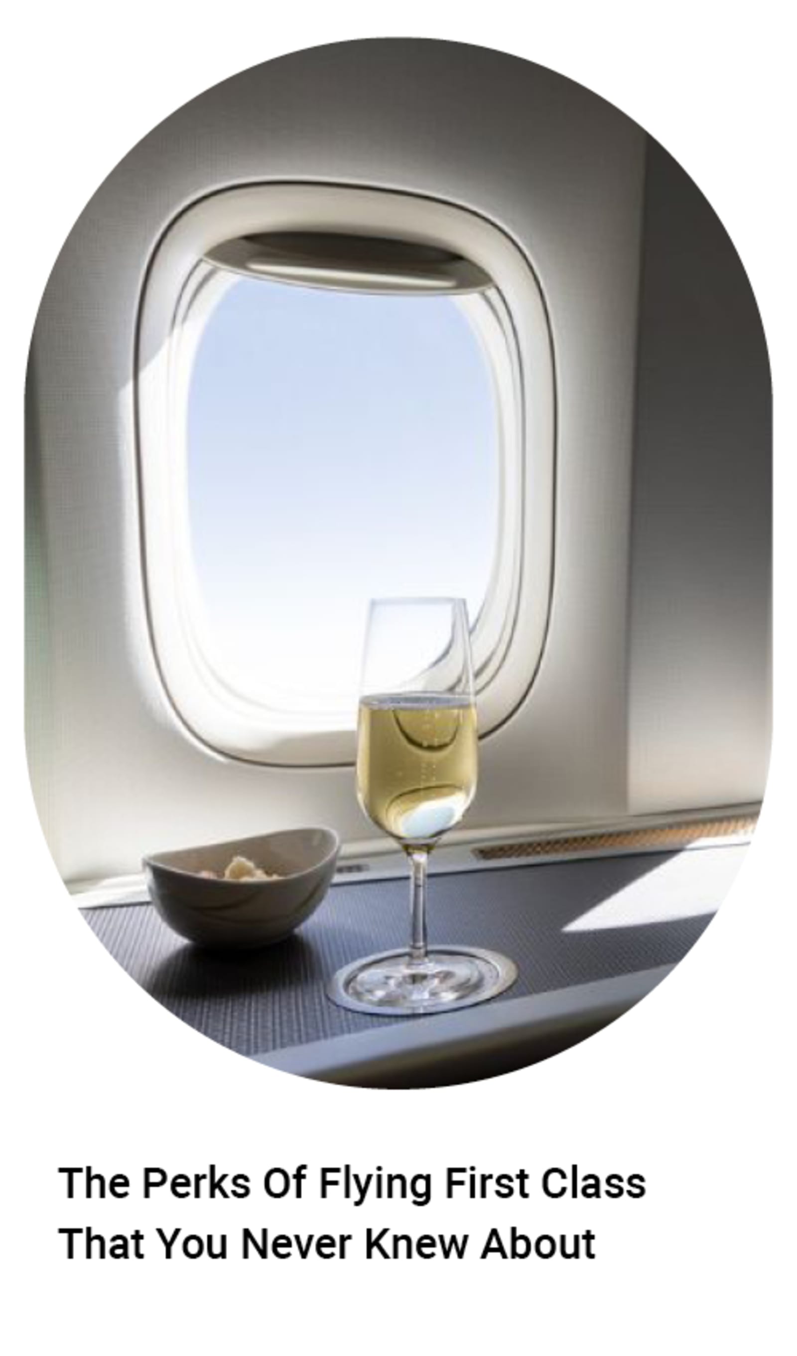 Wine and a bowl in front of an airplane window - The perks of flying first class that you never knew about