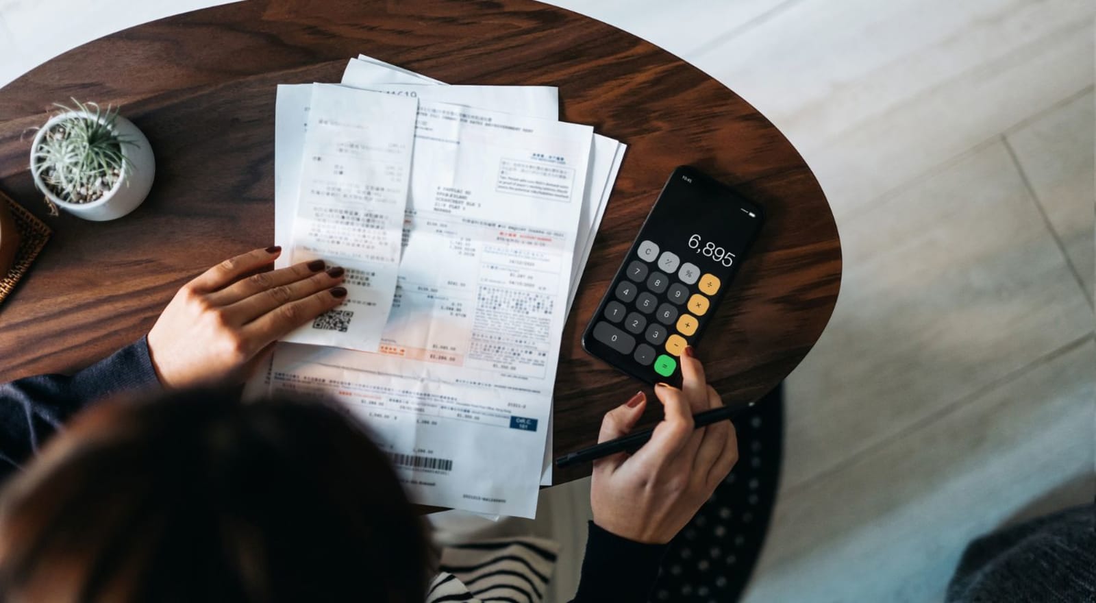 lady using calculator app to calcuate finances