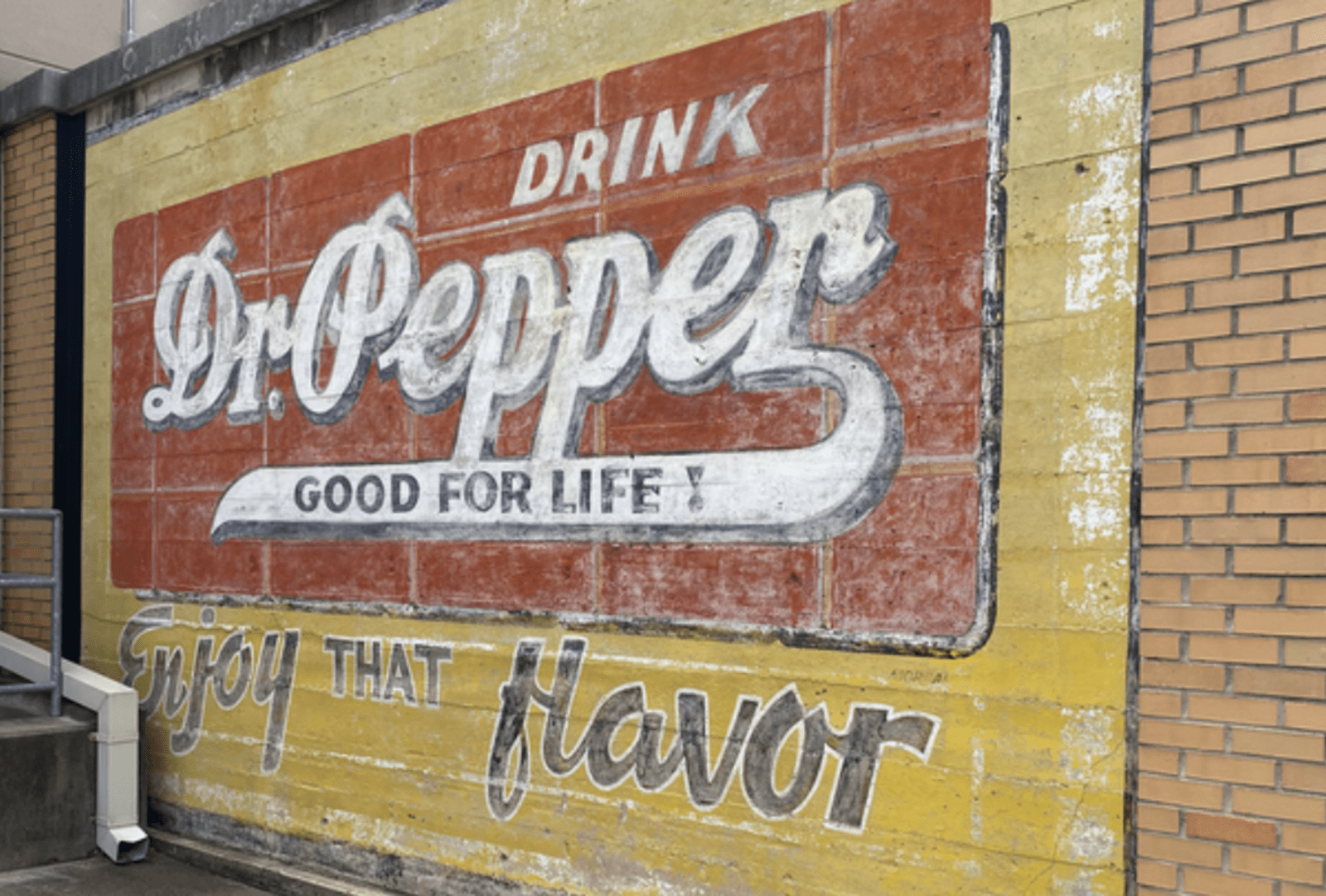 Retro style Dr Pepper ad on an exterior wall, Waco, Texas. 