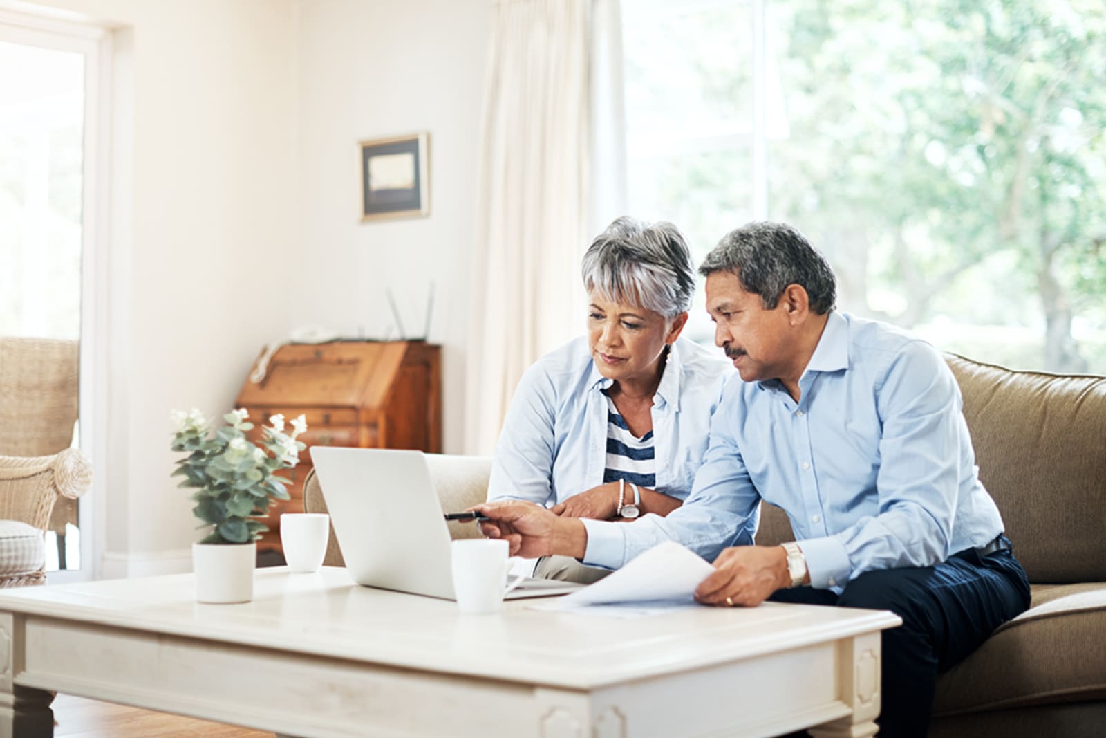 A senior couple reviewing travel insurance documents