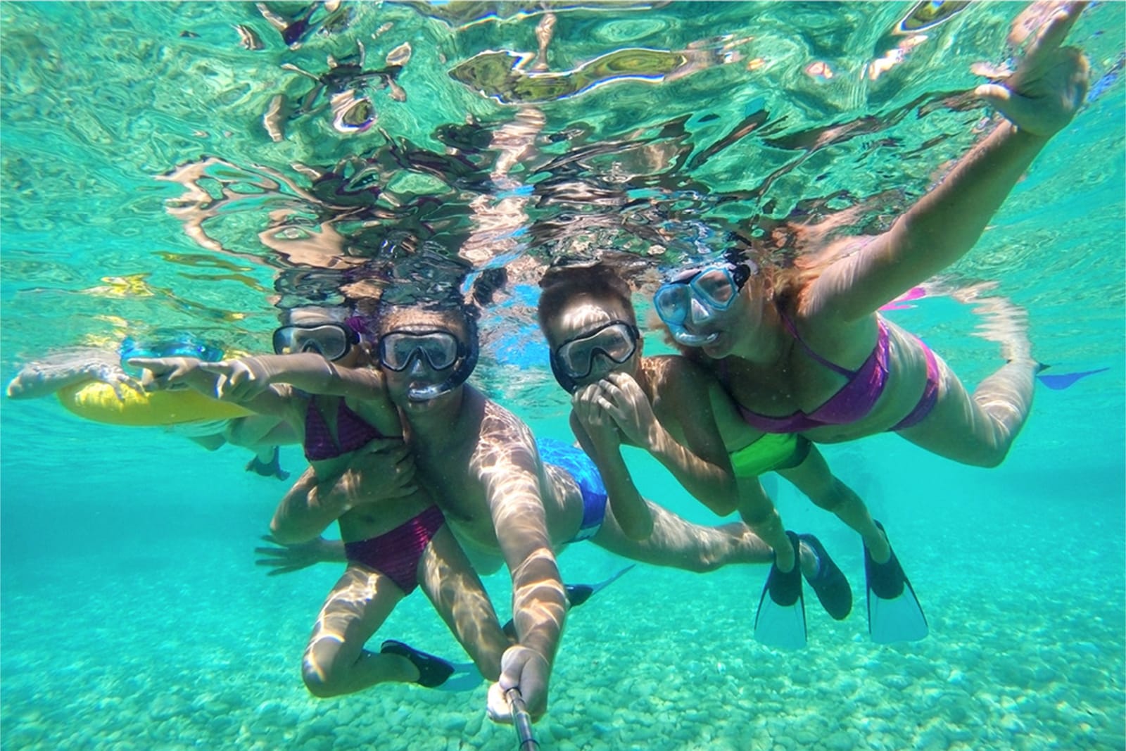 Group of people taking an underwater selfie while snorkeling in Mexico