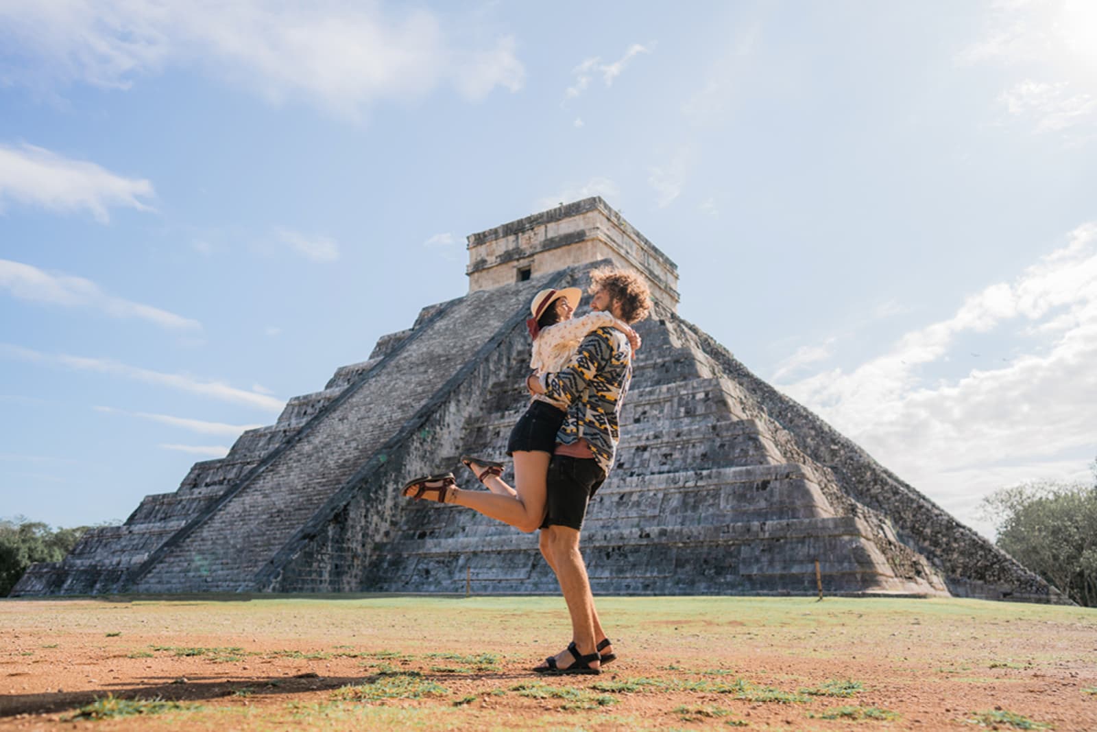 A couple embracing in front of Mayan ruins