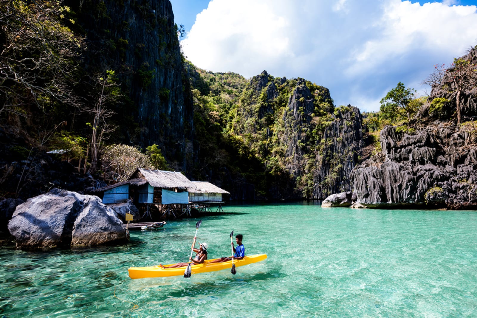 Two people in a kayak, exploring the islands in the Philippines