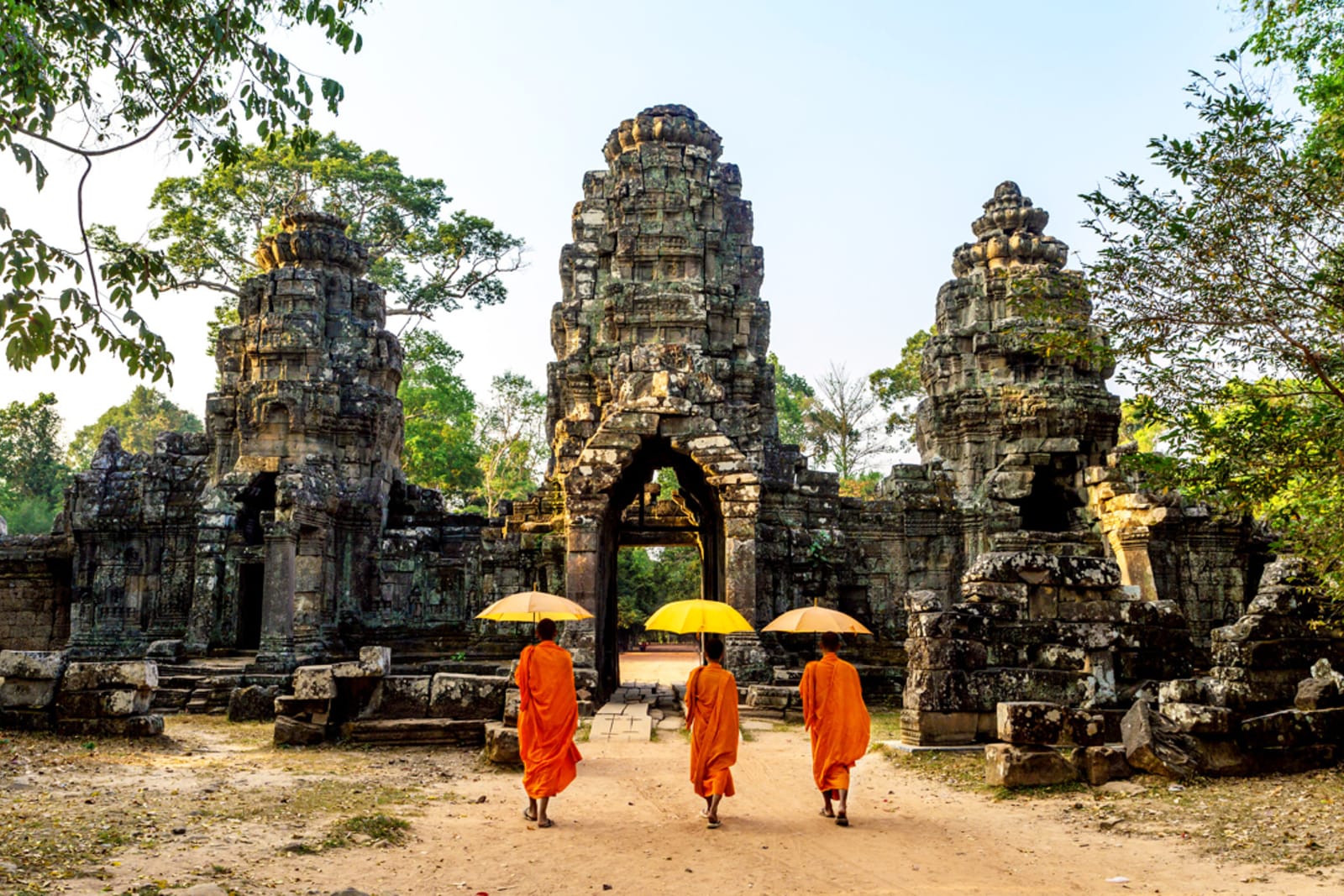 Monks walking toward an ancient structure at Angkor Wat