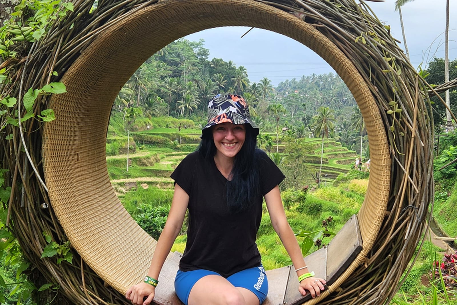 Flight Centre travel consultant Mara Campbell sitting on a swing at rice terraces in Bali