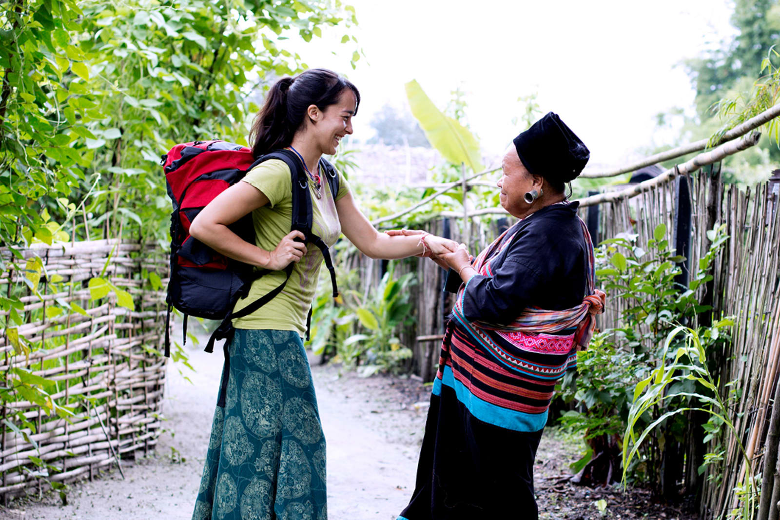 A travellers meets with a member of a local community during a volunteer trip