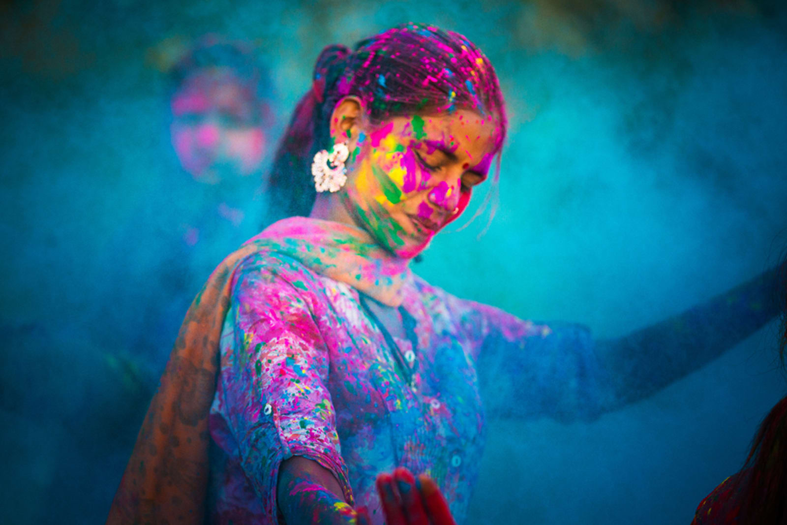 Woman covered in colourful pigments during Holi festival in India