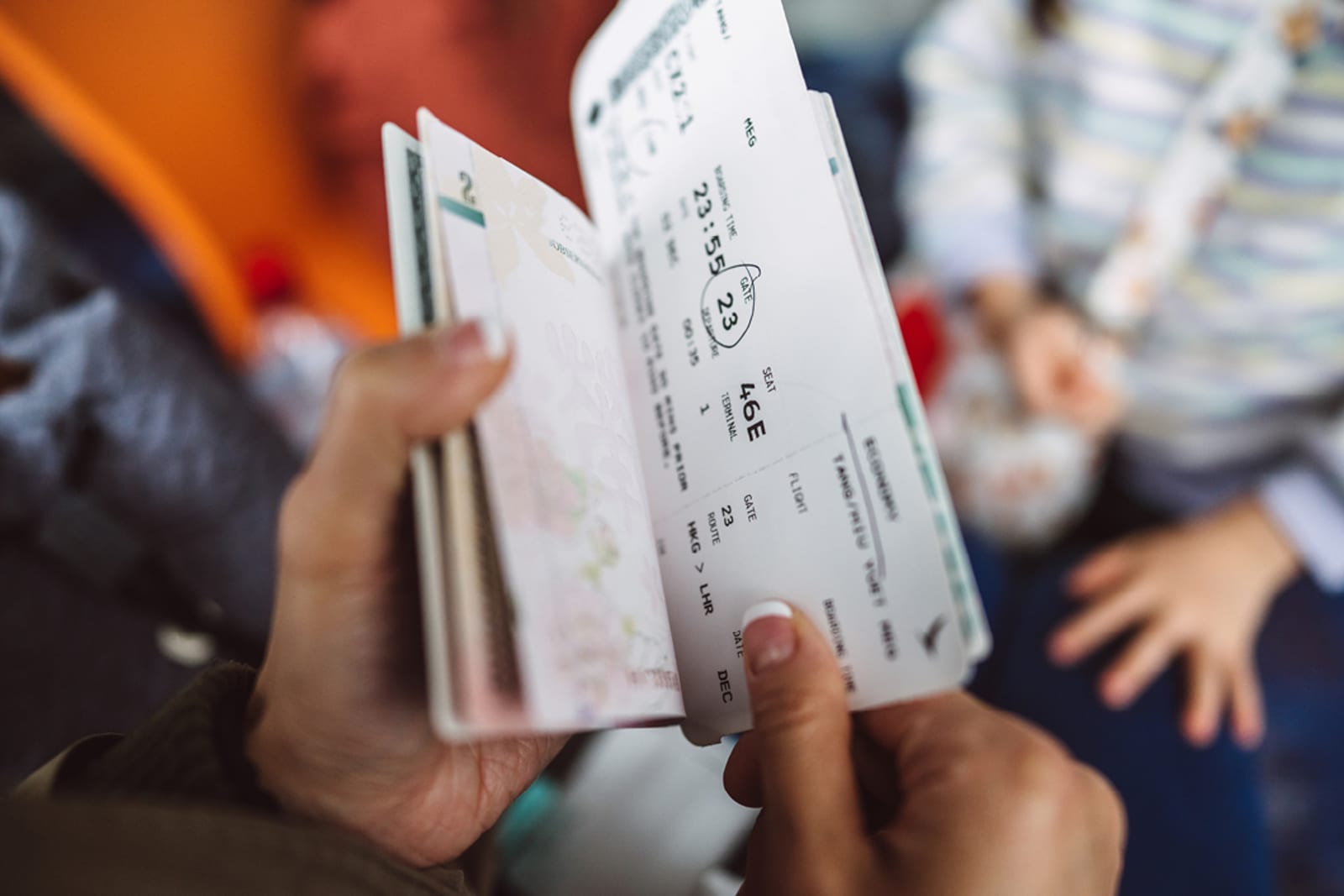 A person holding their boarding passes and passport