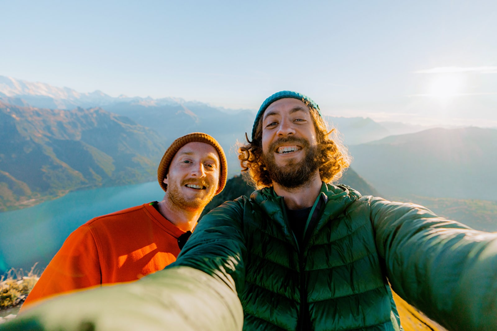 Hikers taking a selfie at the top of a mountain peak