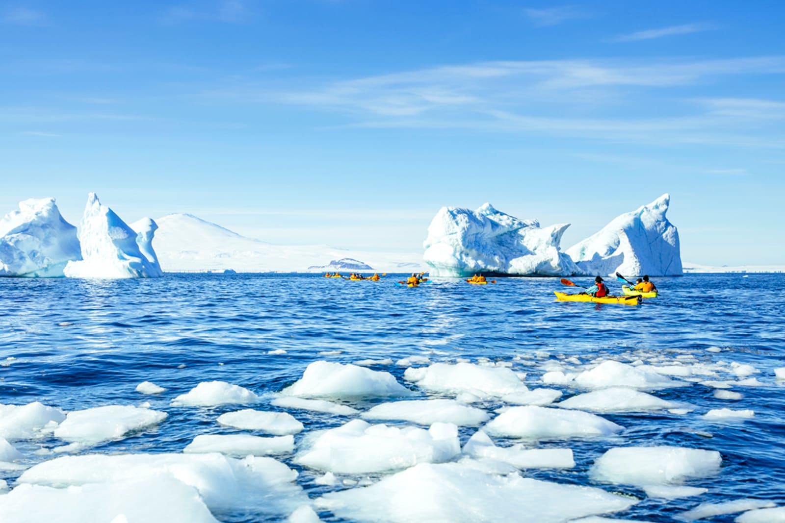 A group of travellers kayaking in Antarctica's Terra Nova Bay