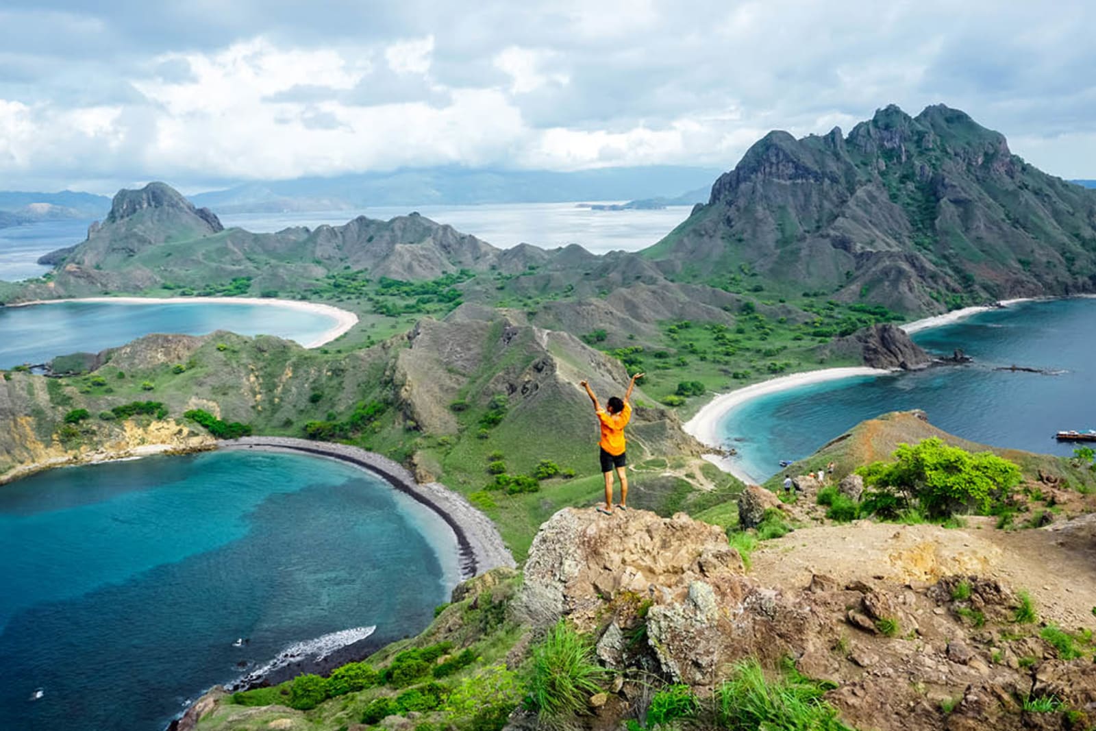 A traveller standing at the top of Padar Island in Komodo National Park, Indonesia