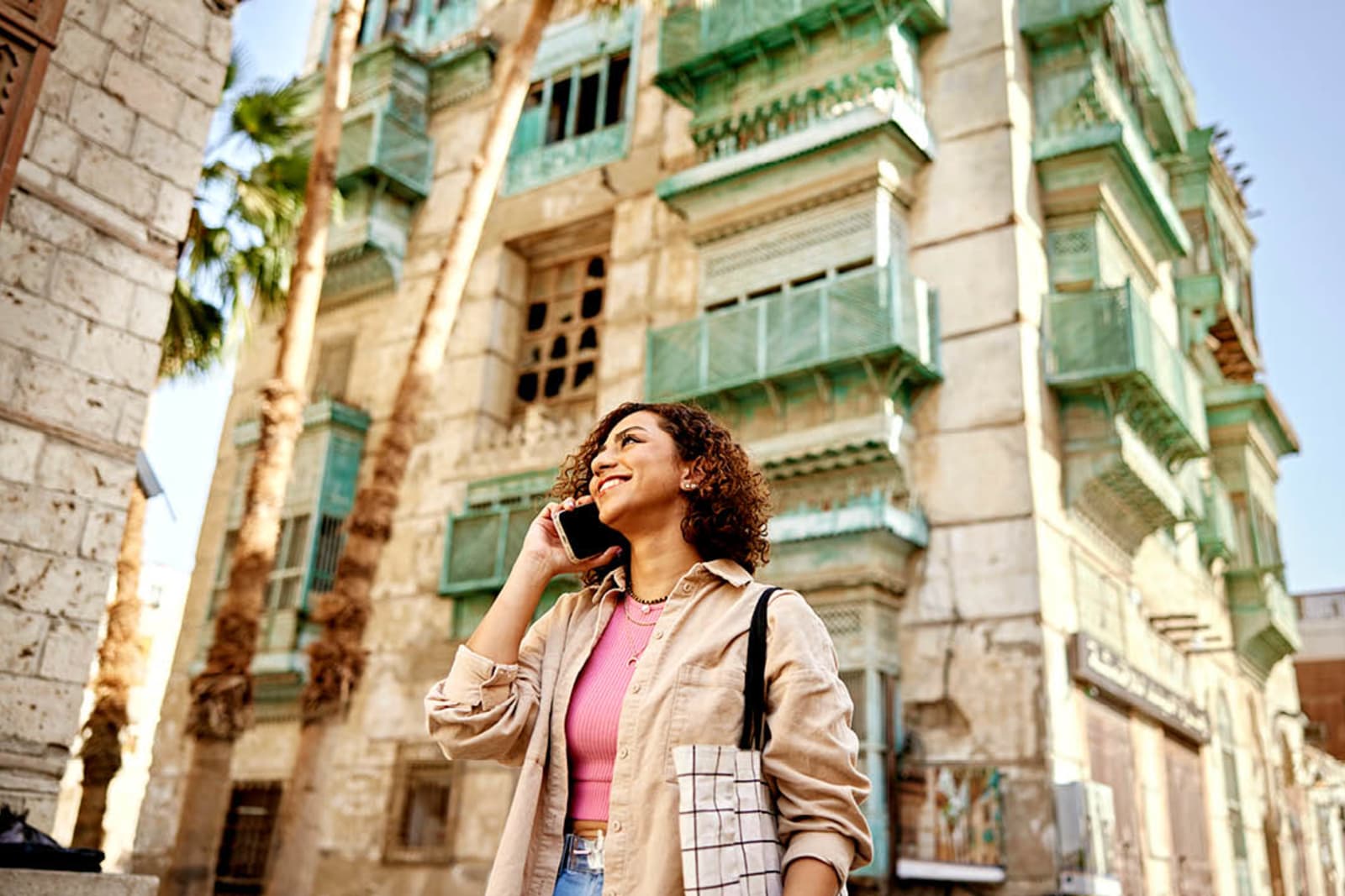 A woman in Al-Balad; she's speaking on a cell phone