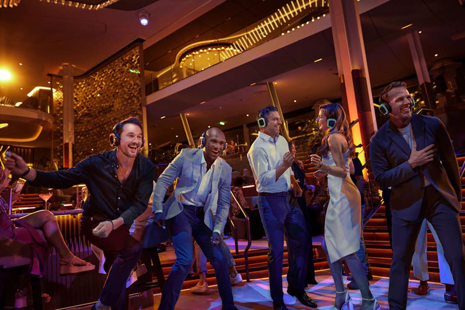 A group of people dancing at a silent disco aboard a cruise ship