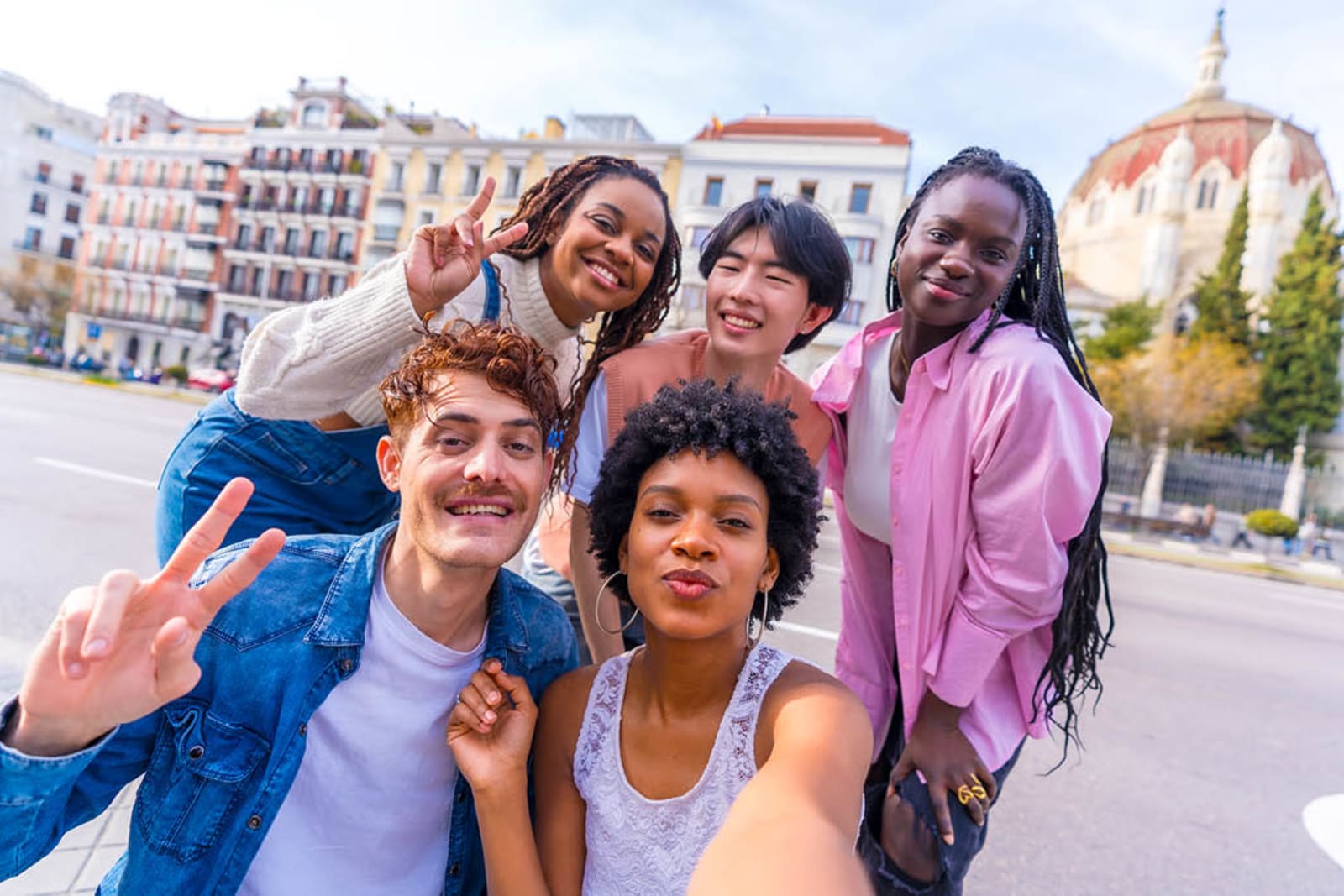 A group of five friends posing for a selfie in Spain