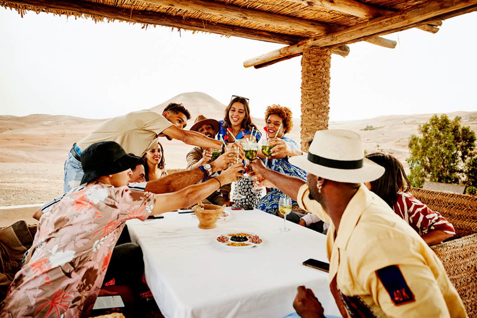 Friends celebrating first night of group trip with drinks and dinner