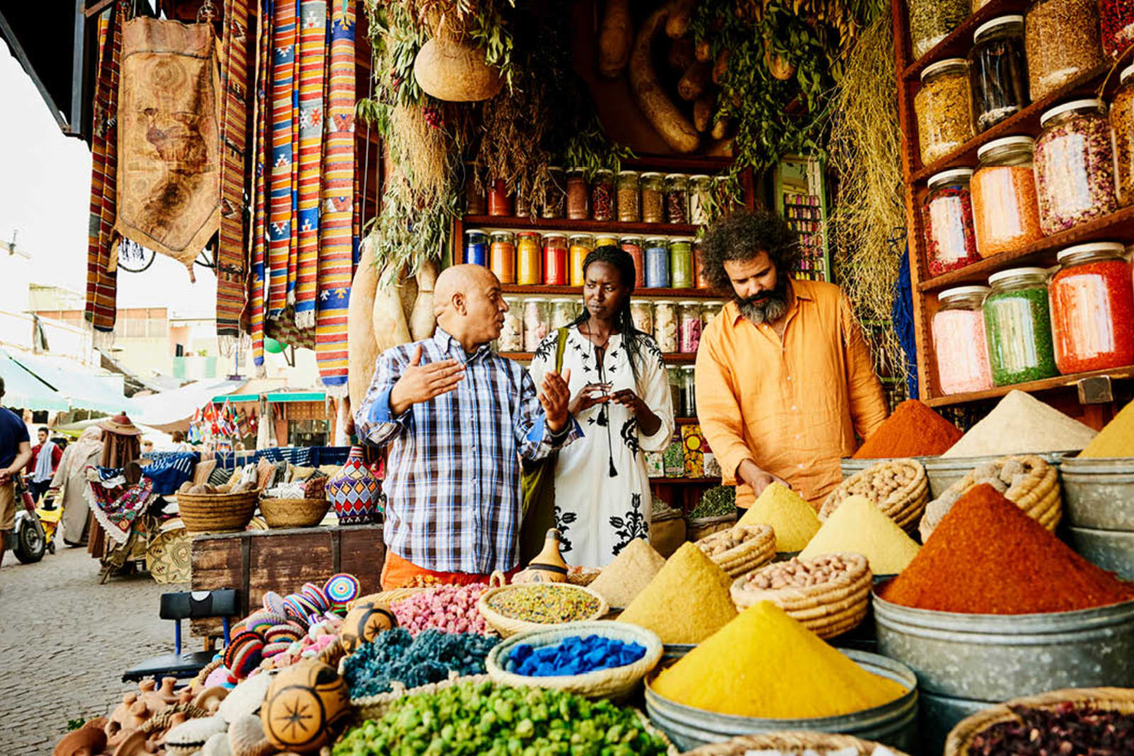 Traveller speaking to a local vendor at a spice market