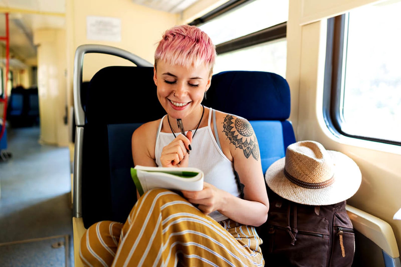 Traveller writing in a notebook while riding a train