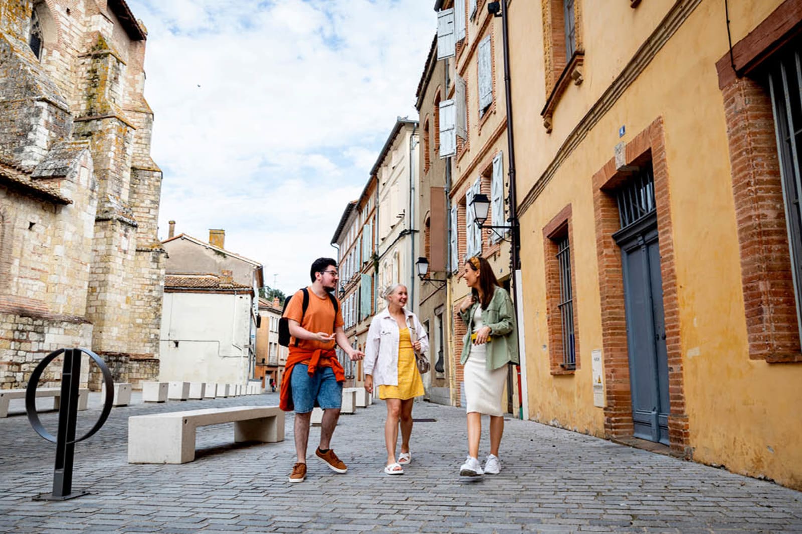 Small group of travellers walking on European street