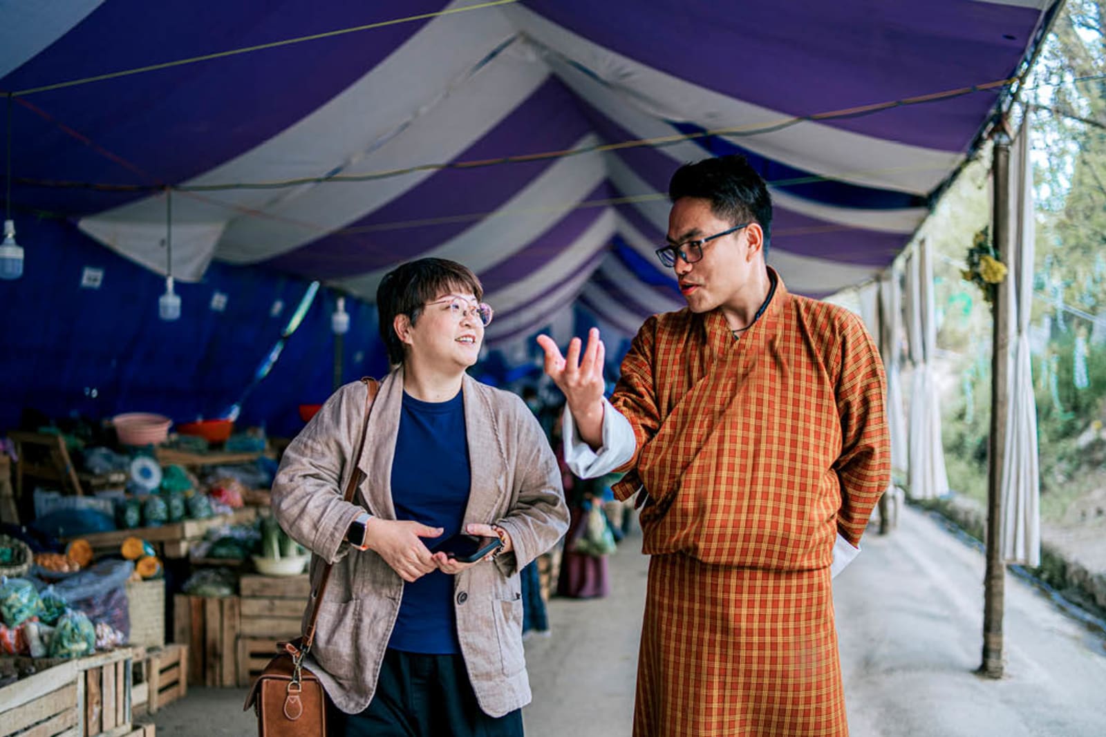 Bhutanese tour guide speaking and gesturing to a traveller