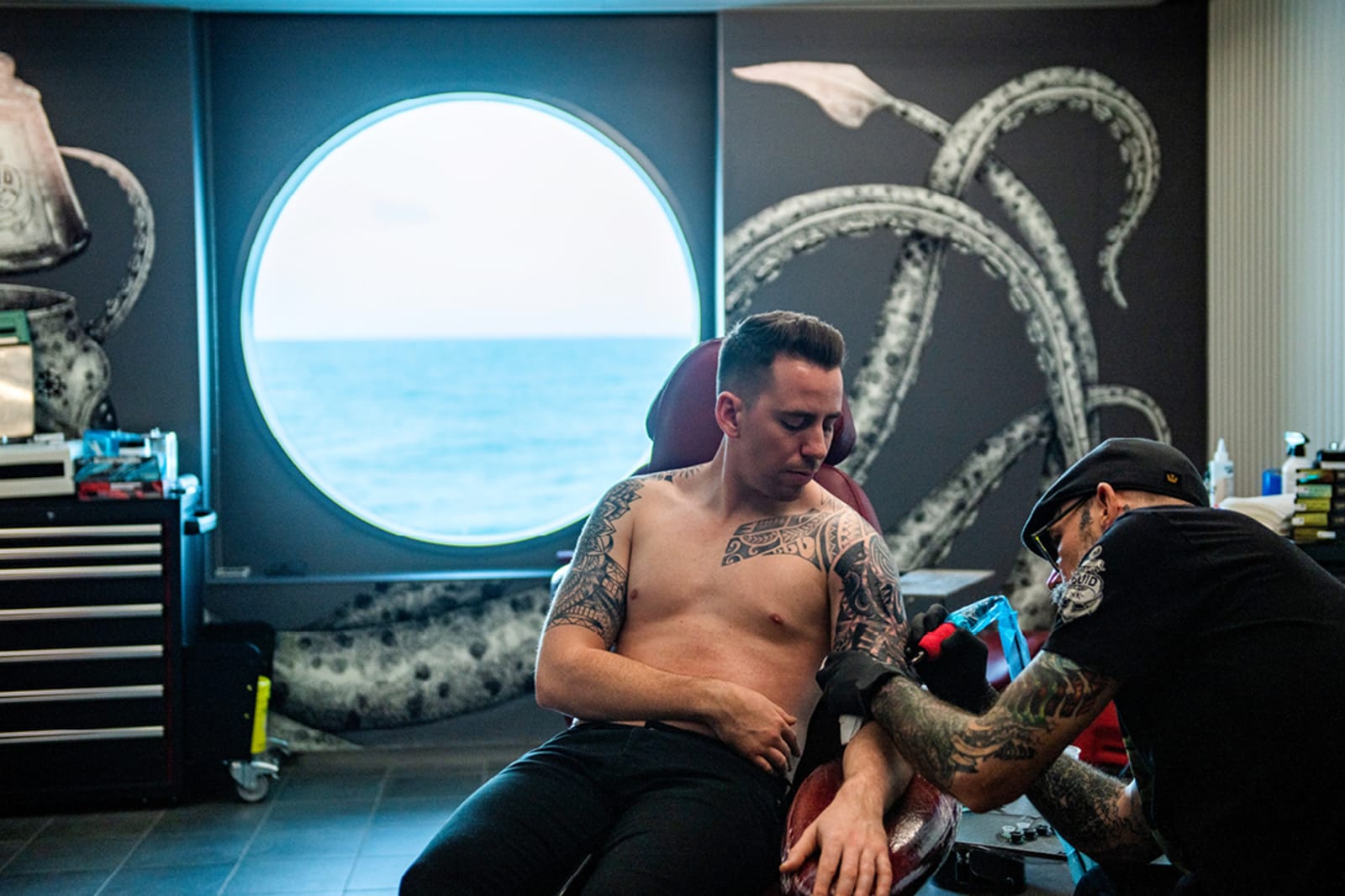 A passenger getting a tattoo aboard a Virgin Voyages ship