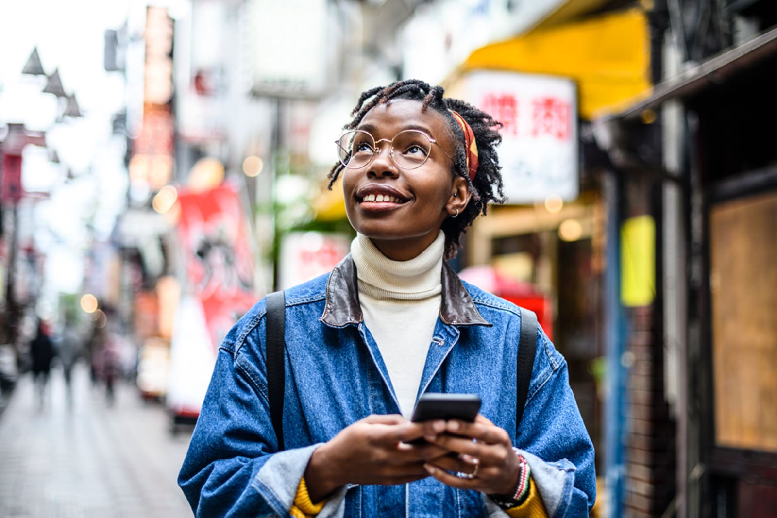 Traveller using a cellphone to help navigate in Tokyo, Japan