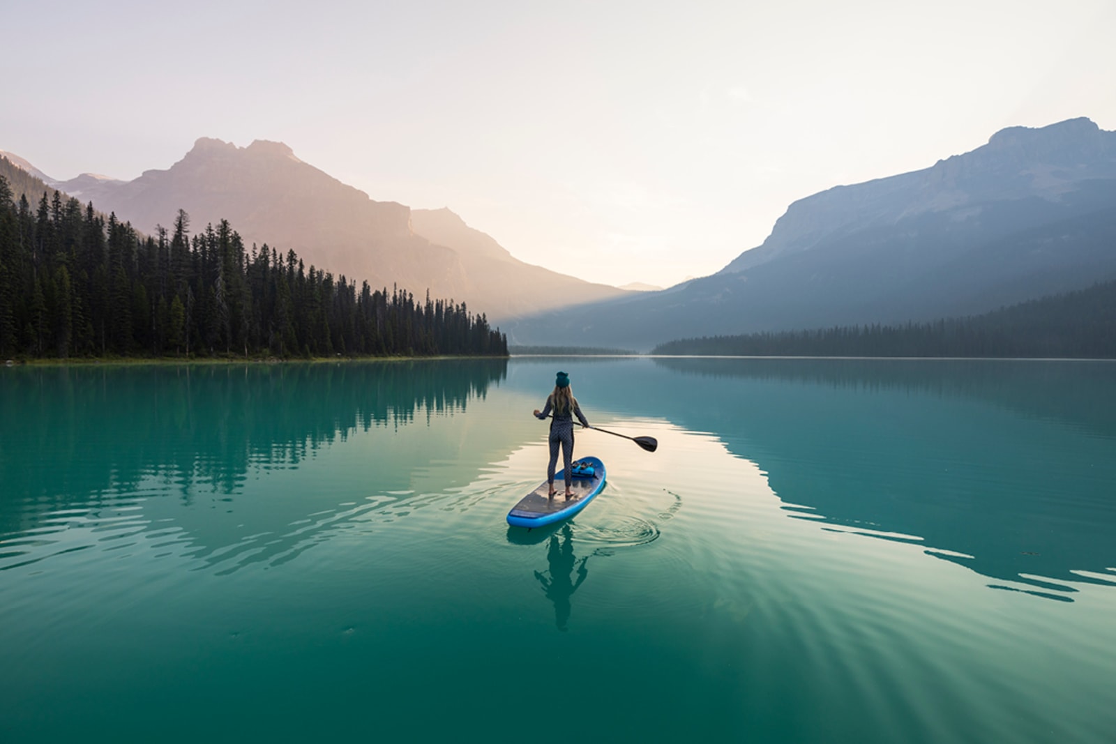 Woman paddleboarding on Emerald Lake in British Columbia, Canada