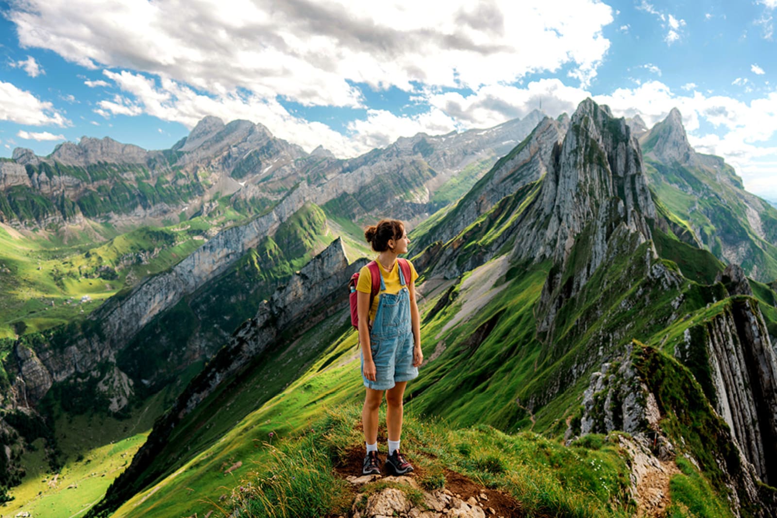 Traveller at top of mountain peak