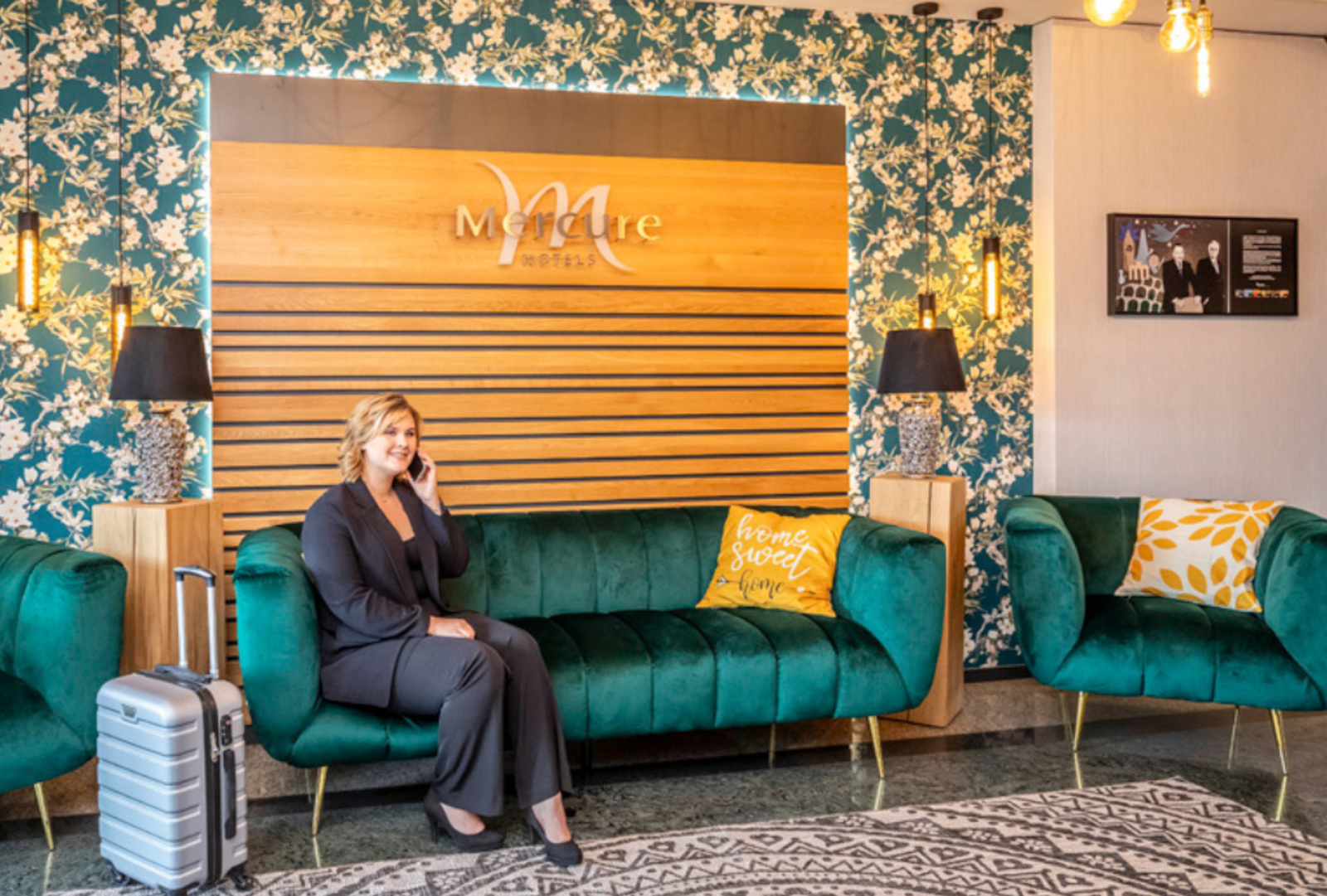 A person talks on the phone in the foyer of a Mercure hotel