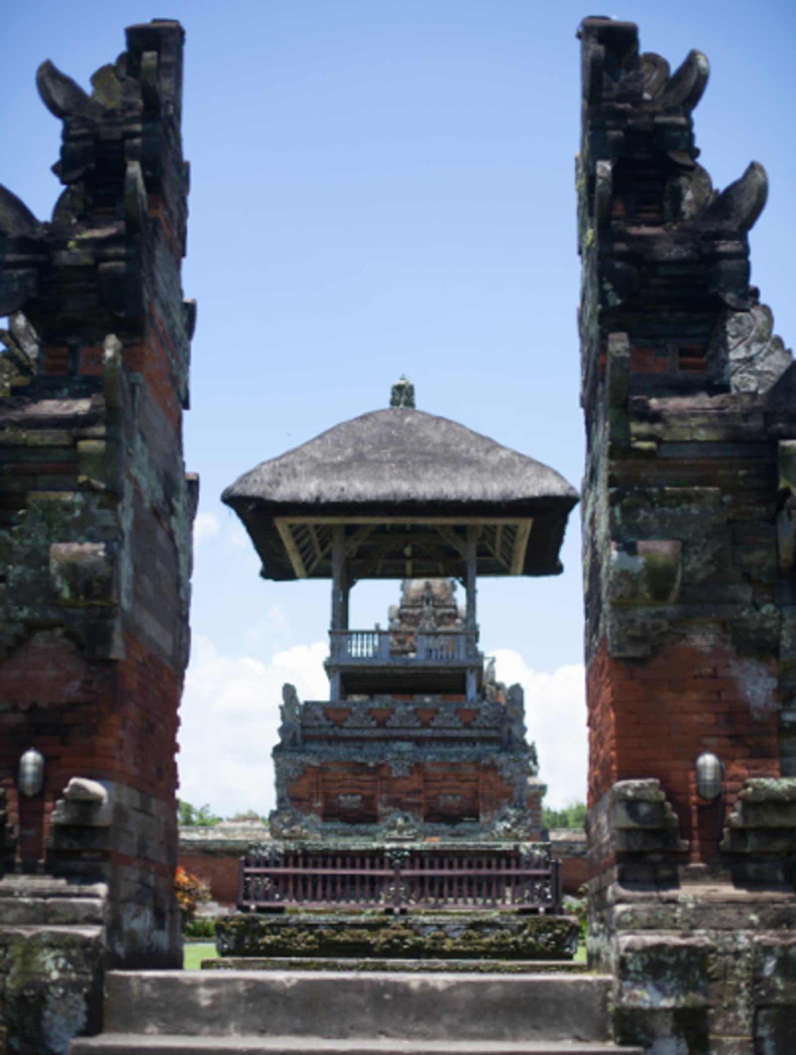 Pura Taman Ayun - temple with imposing spires built alongside, on a bright sunny day