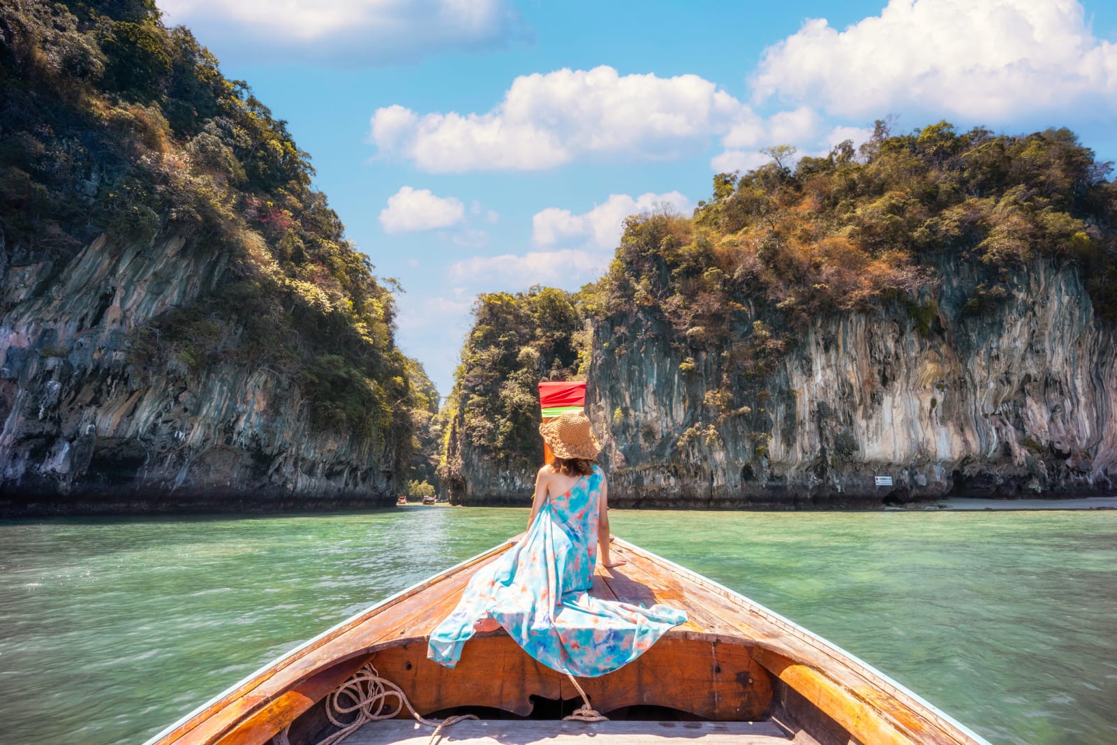 One tourist woman sitting on a longtail boat in Maya Bay, Phi Phi Islands, Thailand