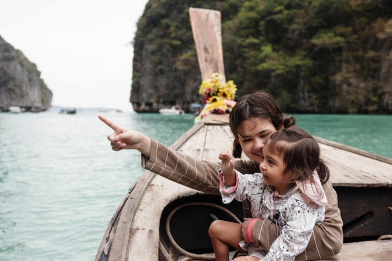 mum and child on a boat in thailand